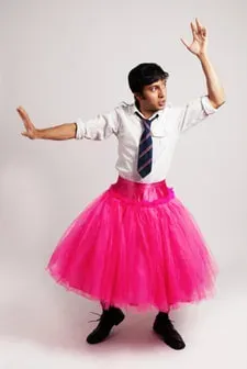 Man in a pink tutu with a white button down shirt and tie