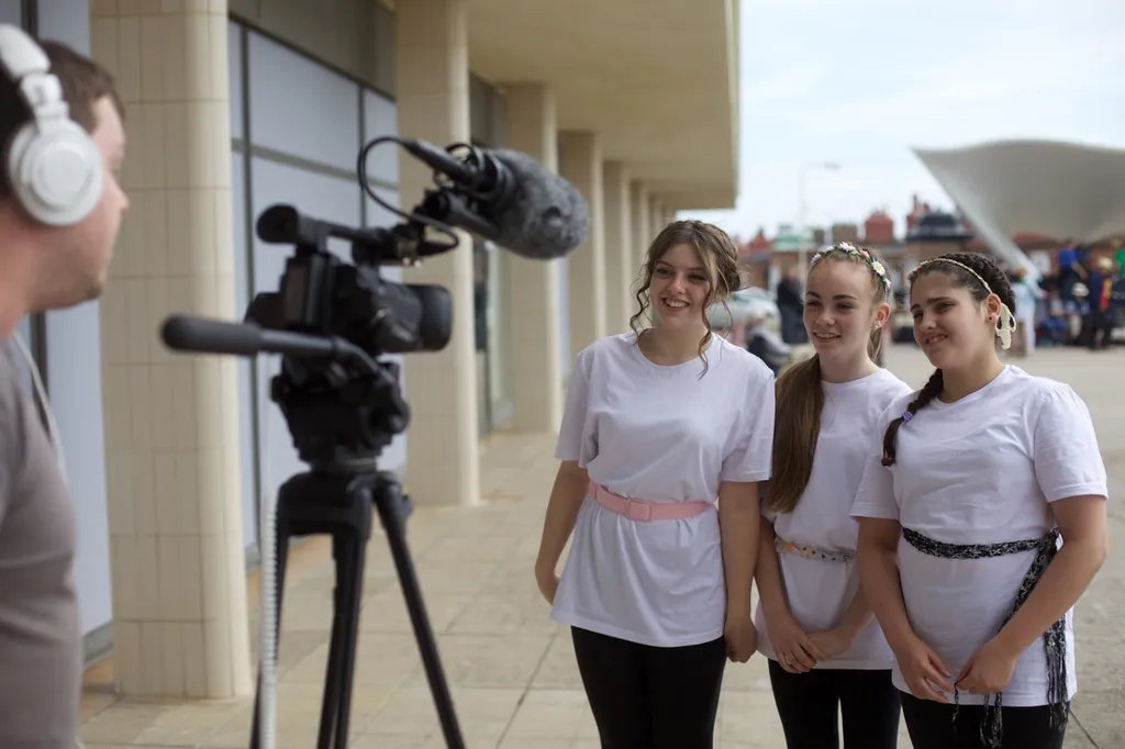 Students talking to camera after performance