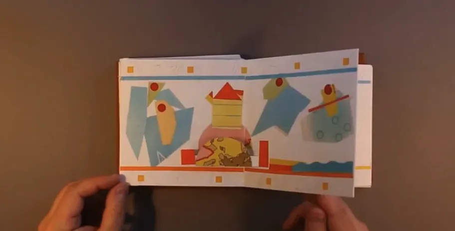 Man sitting with an accordion book workshop set up on the table